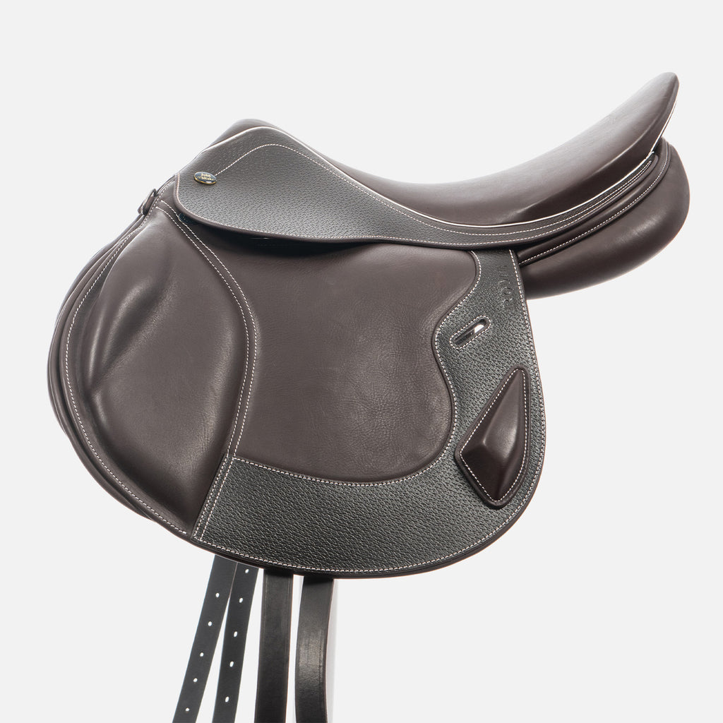 Brown leather saddle on a white background