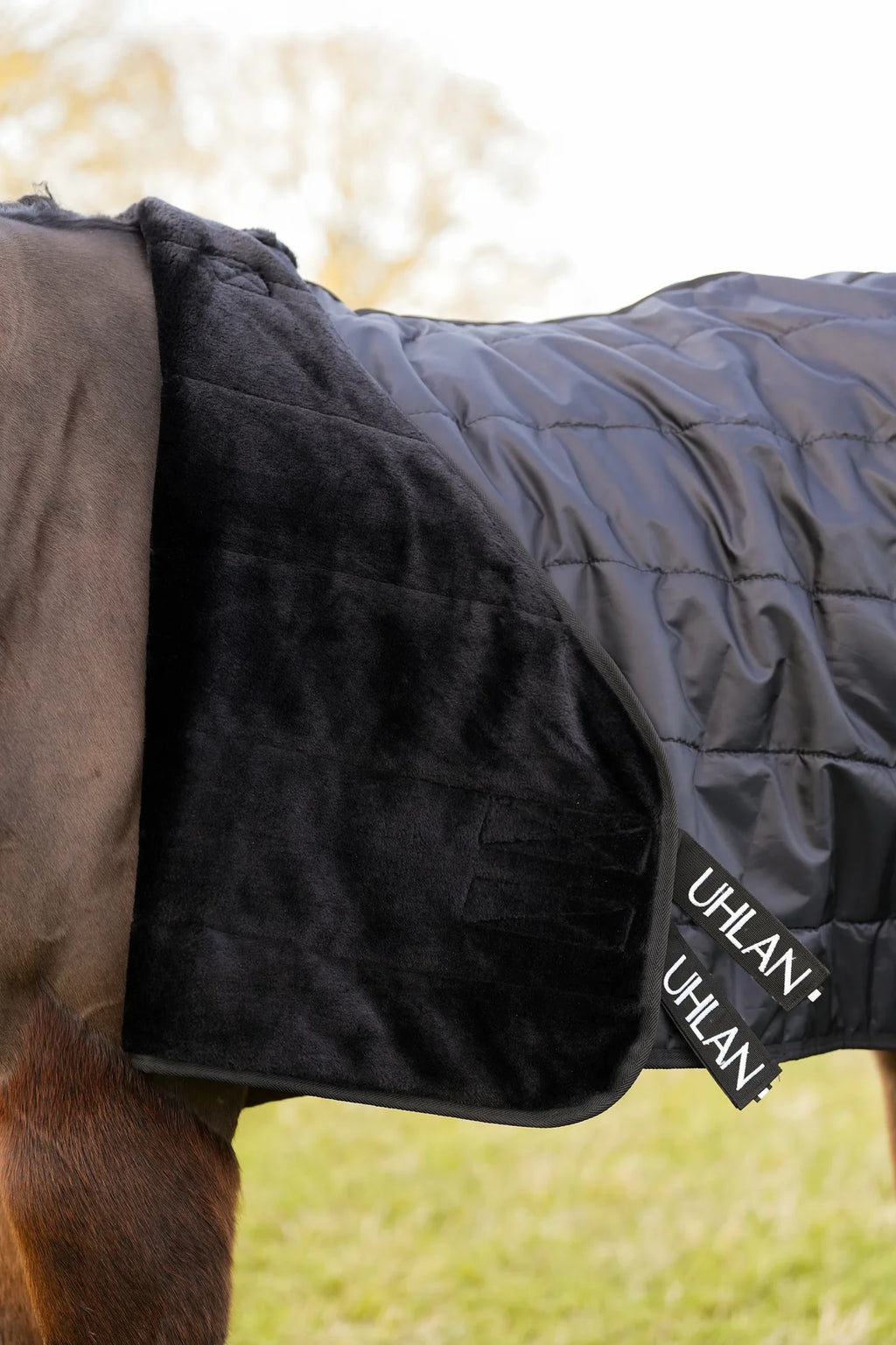 Uhlan Equestrian showing front of the liner rug with the black faux fur lining